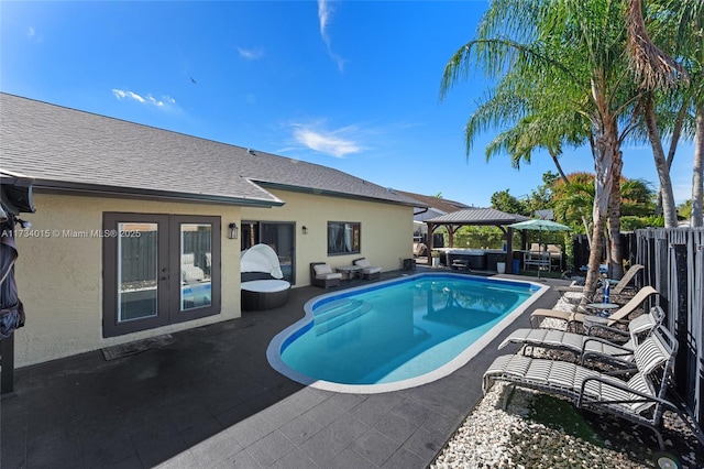 view of swimming pool featuring a gazebo, a patio, and french doors