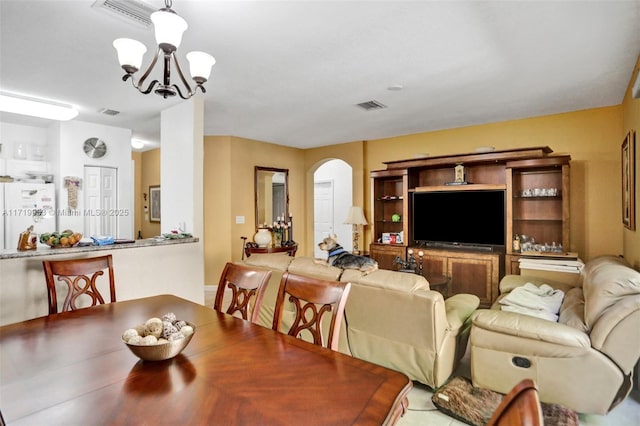 dining area featuring an inviting chandelier