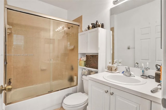 full bathroom featuring vanity, enclosed tub / shower combo, and toilet