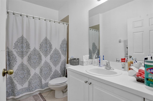 bathroom featuring vanity, toilet, and tile patterned flooring