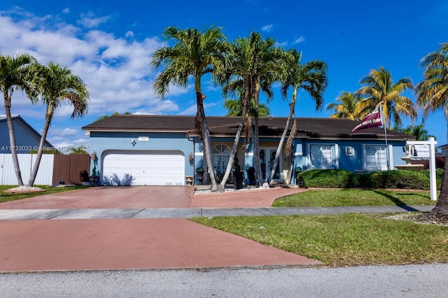 single story home with a garage and a front yard