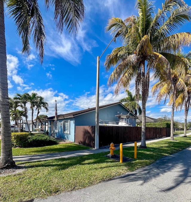 view of side of property with a lawn