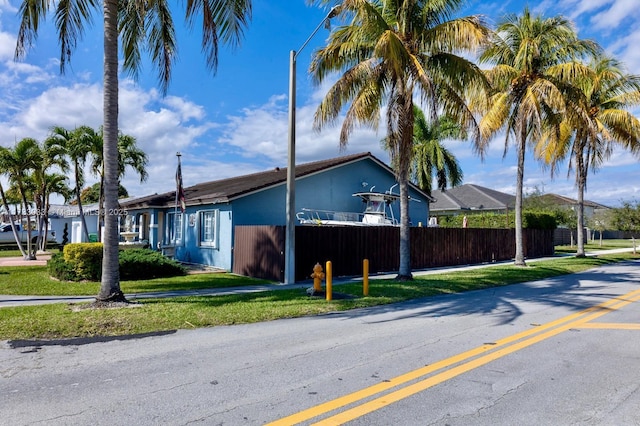 view of side of property with a yard