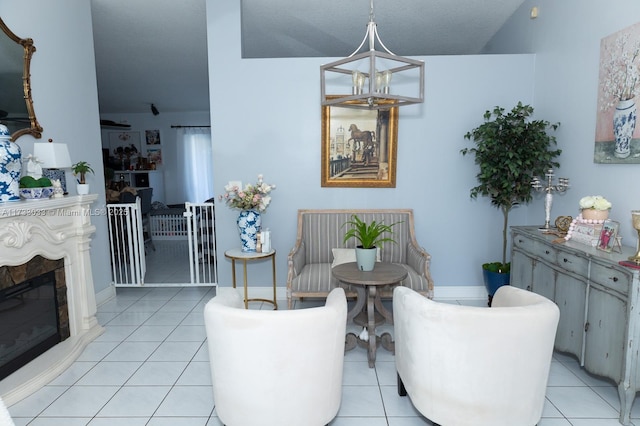 sitting room with light tile patterned floors, a notable chandelier, and a textured ceiling