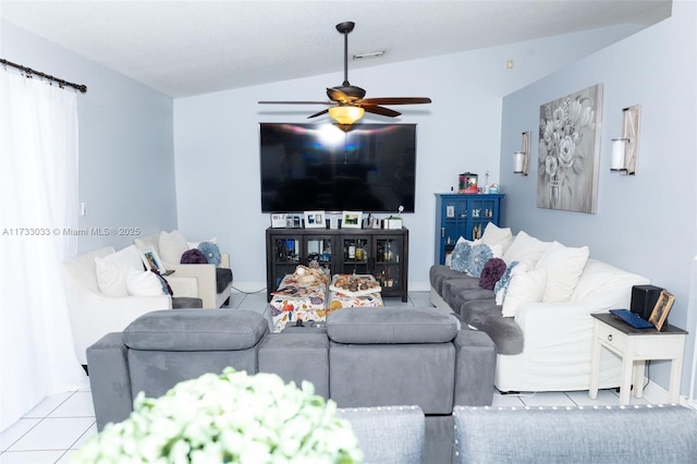 living room with vaulted ceiling, light tile patterned floors, and ceiling fan