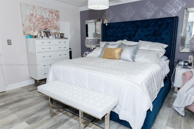 bedroom featuring light hardwood / wood-style flooring and ornamental molding