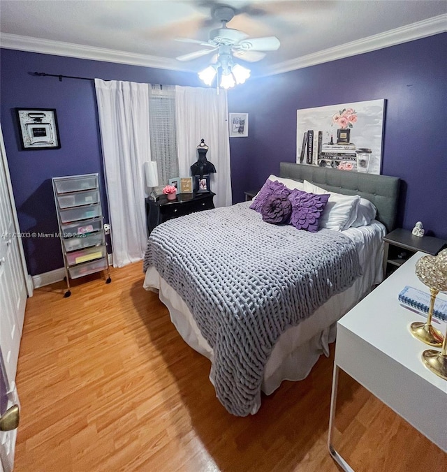 bedroom with crown molding, ceiling fan, and hardwood / wood-style flooring