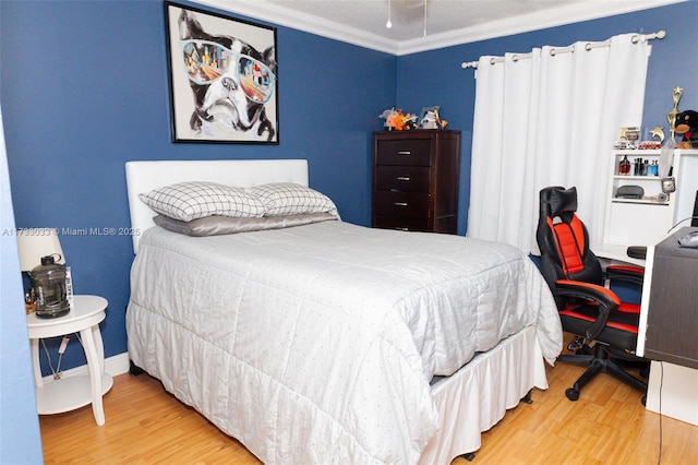 bedroom featuring crown molding and wood-type flooring