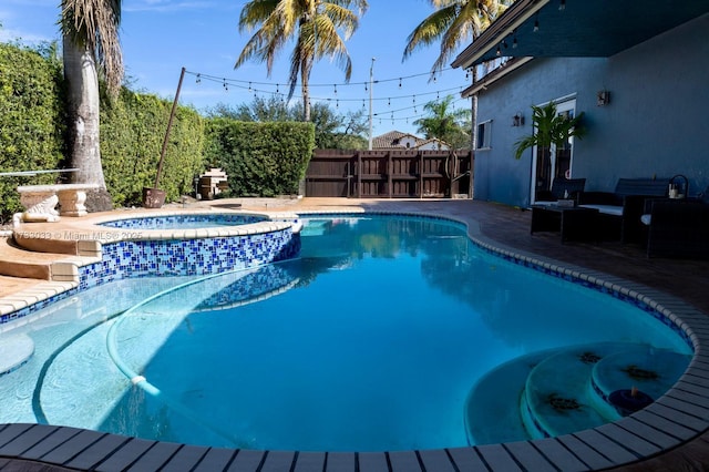 view of pool with an in ground hot tub