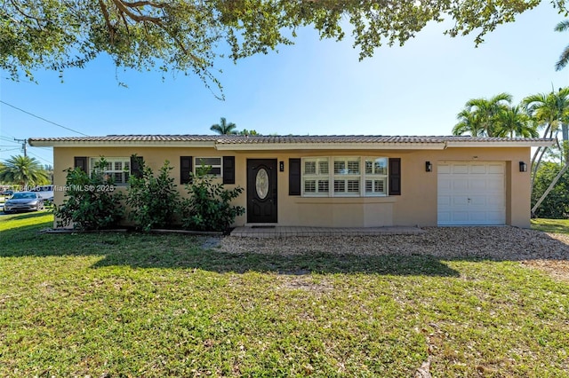 ranch-style home with a garage and a front lawn