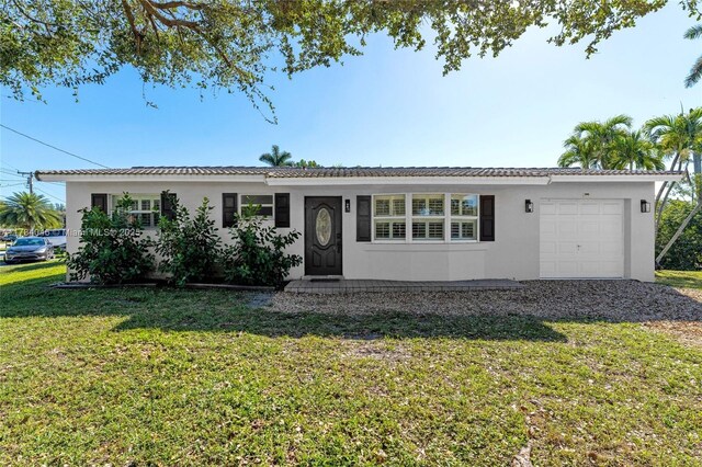 ranch-style home featuring a garage and a front yard