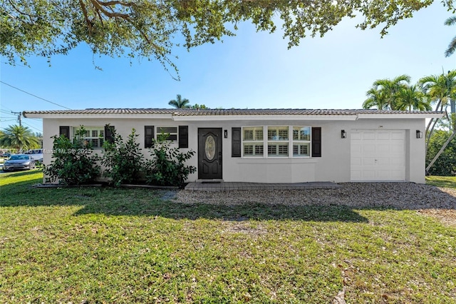 single story home featuring a garage and a front lawn