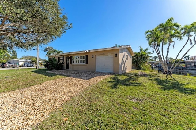 view of front of property with a garage and a front yard