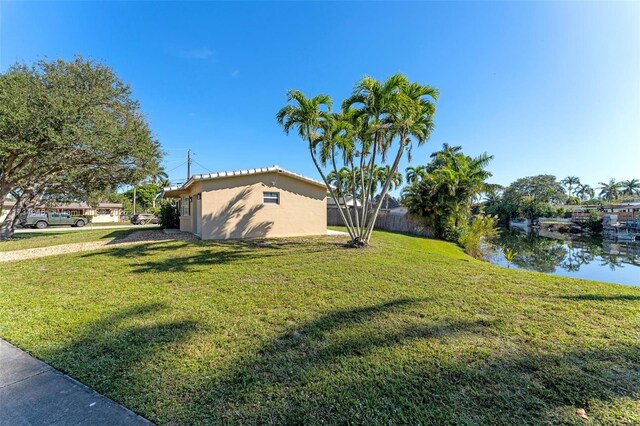 view of side of property with a lawn