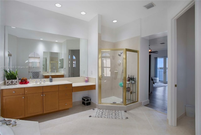 bathroom with tile patterned flooring, vanity, toilet, and an enclosed shower