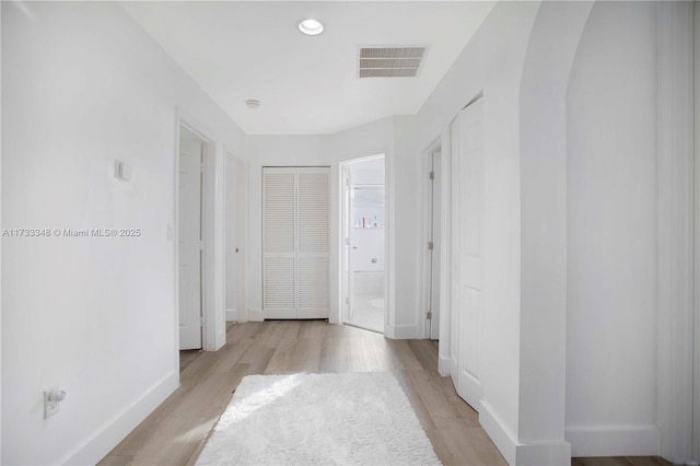 corridor with light hardwood / wood-style flooring