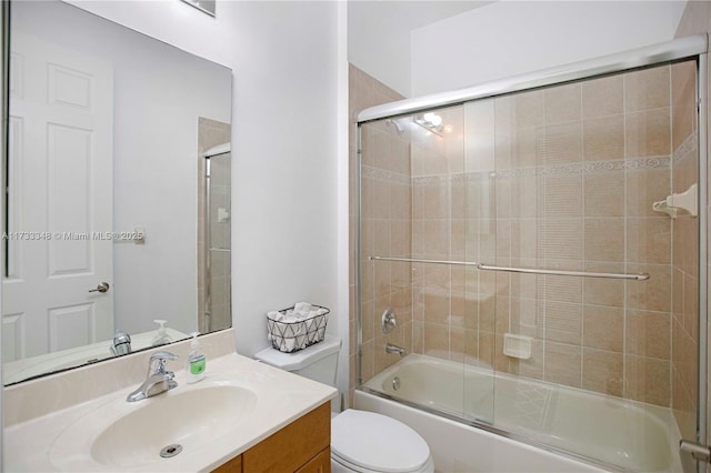 full bathroom with vanity, shower / bath combination with glass door, and toilet