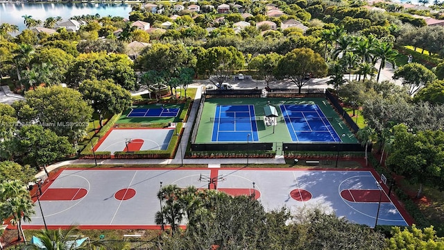 view of basketball court with a water view and tennis court