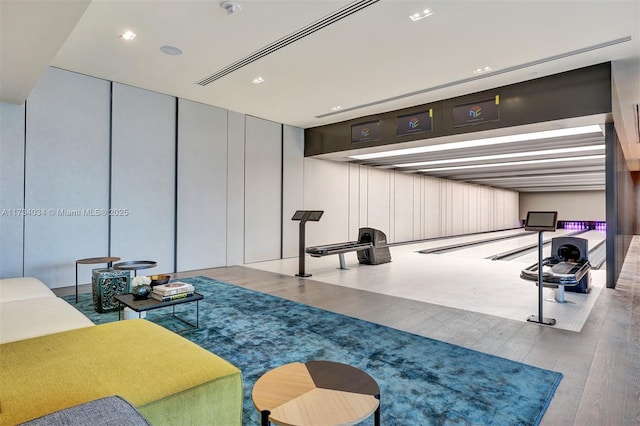 workout area with wood-type flooring and a bowling alley