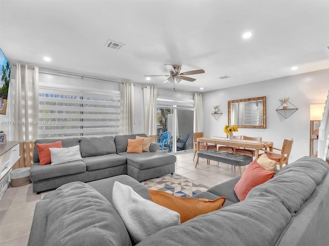 tiled living room with ceiling fan