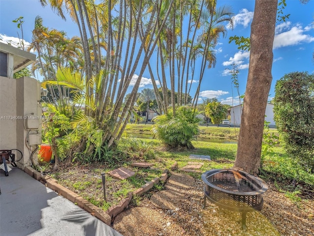 view of yard with an outdoor fire pit