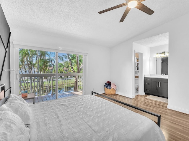 bedroom with connected bathroom, sink, ceiling fan, access to exterior, and light hardwood / wood-style floors