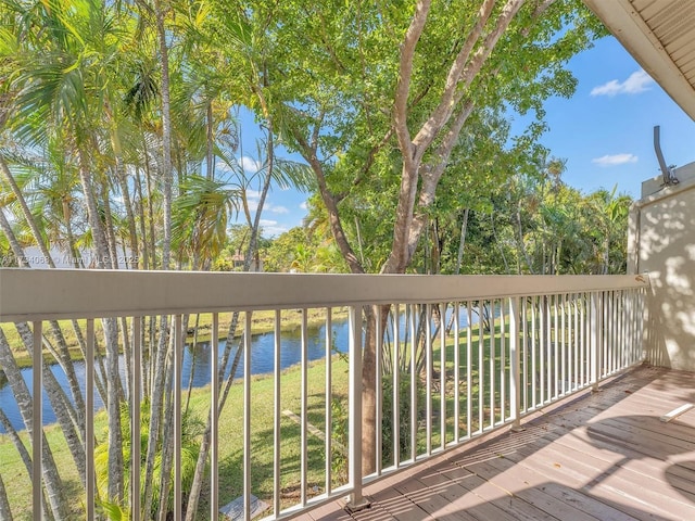 wooden terrace featuring a water view