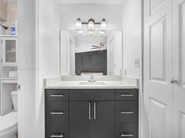 bathroom with vanity, ceiling fan, and toilet