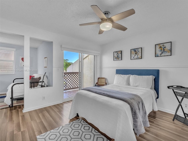 bedroom featuring access to outside, a textured ceiling, ceiling fan, and light hardwood / wood-style floors