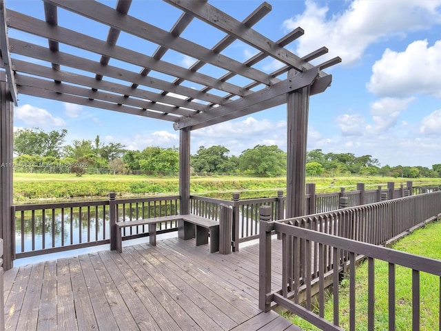 wooden deck with a pergola and a water view