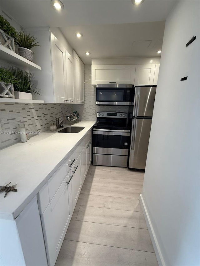 kitchen with white cabinetry, sink, and appliances with stainless steel finishes