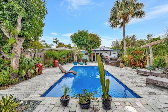 view of swimming pool with a patio, a fenced backyard, and a fenced in pool