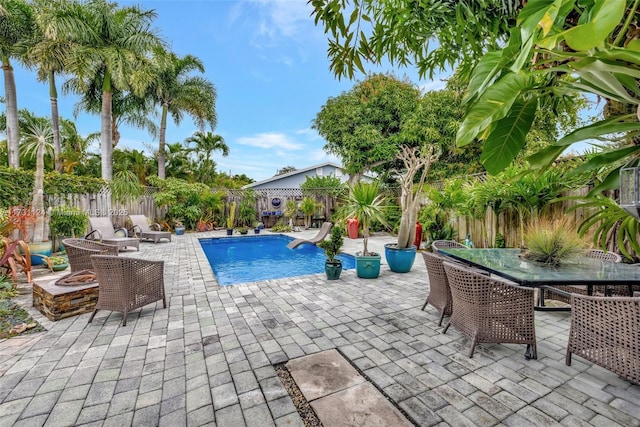 view of swimming pool featuring a fire pit and a patio area