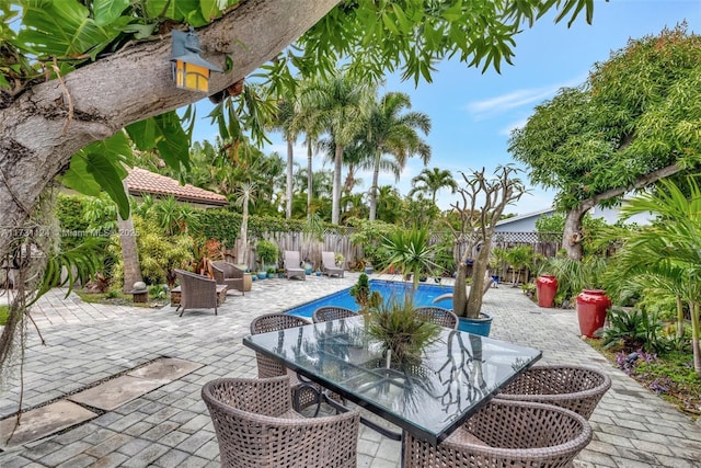 1401 NE 33rd St, Oakland Park, FL 33334 - view of patio / terrace featuring a fenced backyard, a fenced in pool, and outdoor dining space