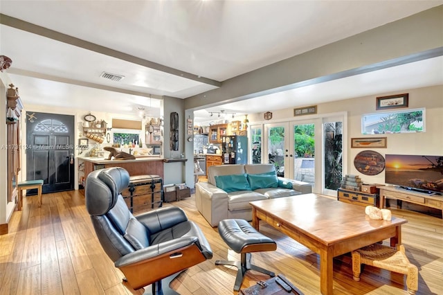 living room featuring light hardwood / wood-style floors and french doors