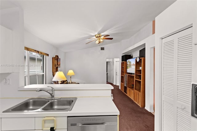 kitchen featuring sink, dark colored carpet, vaulted ceiling, stainless steel dishwasher, and ceiling fan