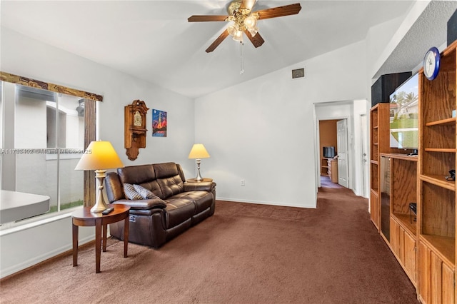 living area featuring ceiling fan, lofted ceiling, dark carpet, and plenty of natural light