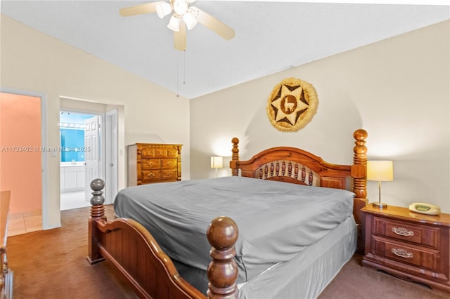 carpeted bedroom featuring ceiling fan, vaulted ceiling, and ensuite bath