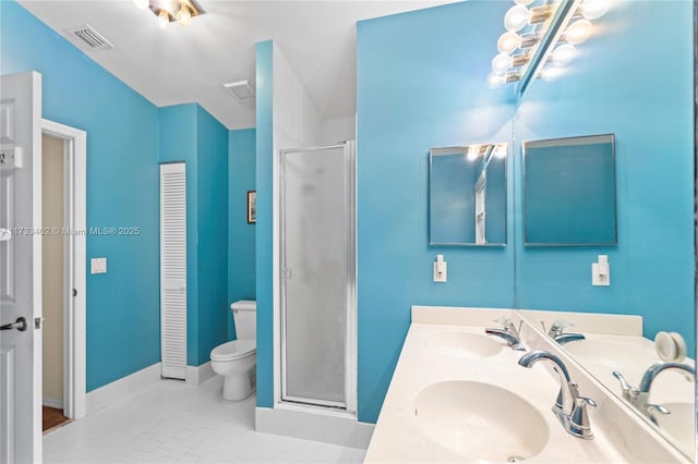 bathroom featuring a shower with door, vanity, tile patterned floors, and toilet