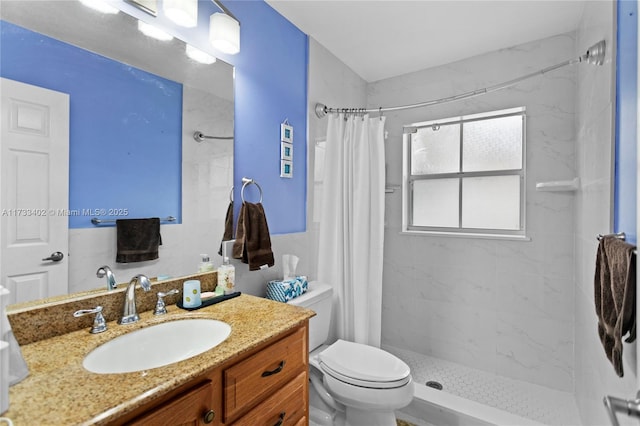 bathroom featuring vanity, walk in shower, and toilet