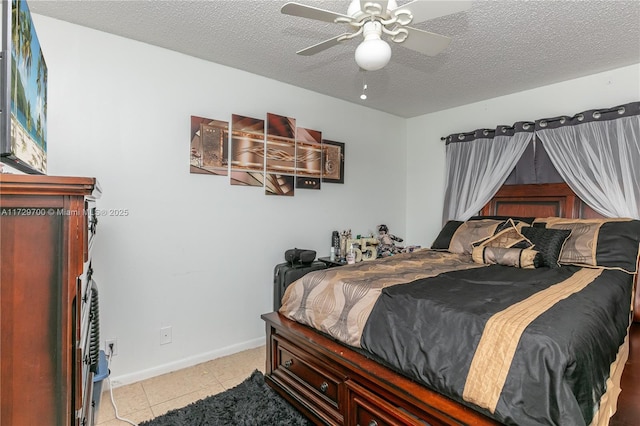 tiled bedroom with a textured ceiling and ceiling fan