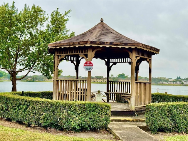 view of property's community with a gazebo and a water view