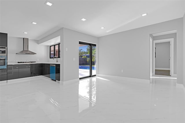 kitchen with marble finish floor, light countertops, a sink, modern cabinets, and wall chimney exhaust hood