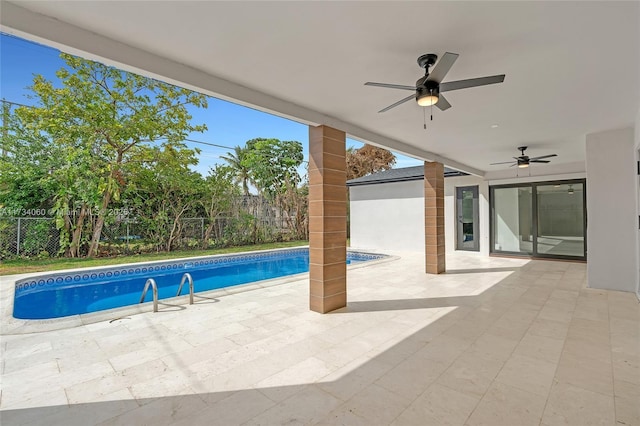 outdoor pool featuring a patio, a fenced backyard, and a ceiling fan