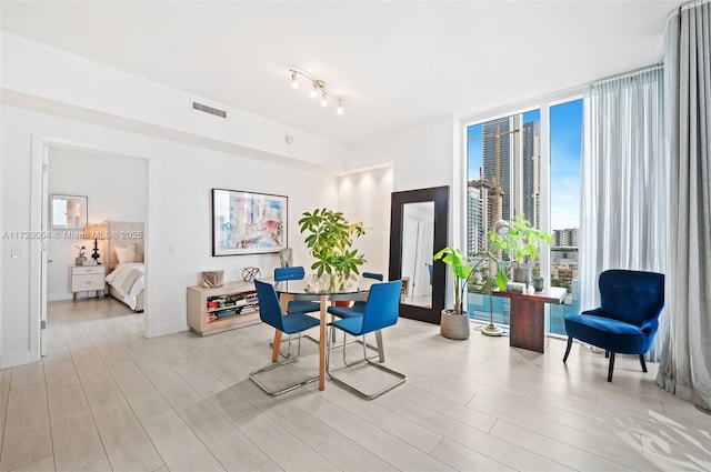 dining space featuring floor to ceiling windows