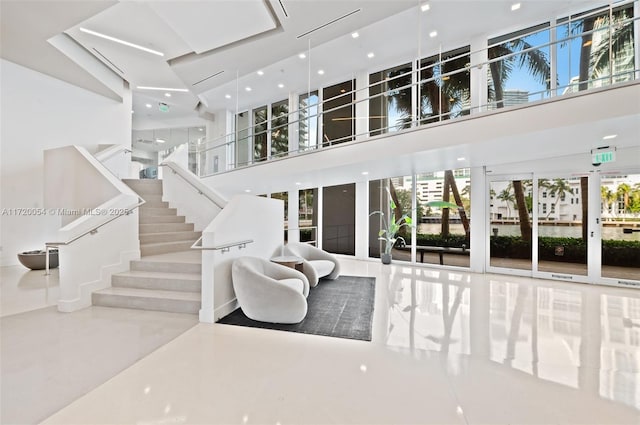 living room featuring a towering ceiling