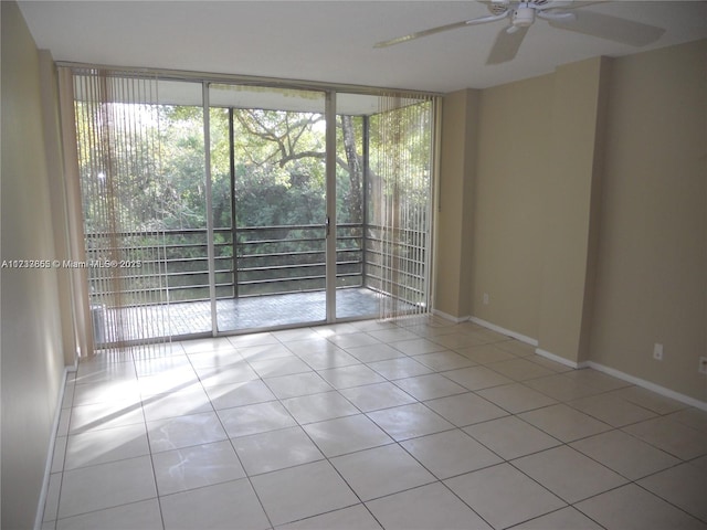 tiled spare room featuring ceiling fan