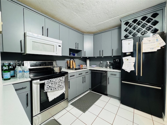 16950 W Dixie Hwy Unit A429, North Miami Beach, FL 33160 - kitchen with electric stove, freestanding refrigerator, white microwave, light countertops, and a textured ceiling