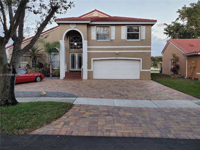 mediterranean / spanish-style home with a garage