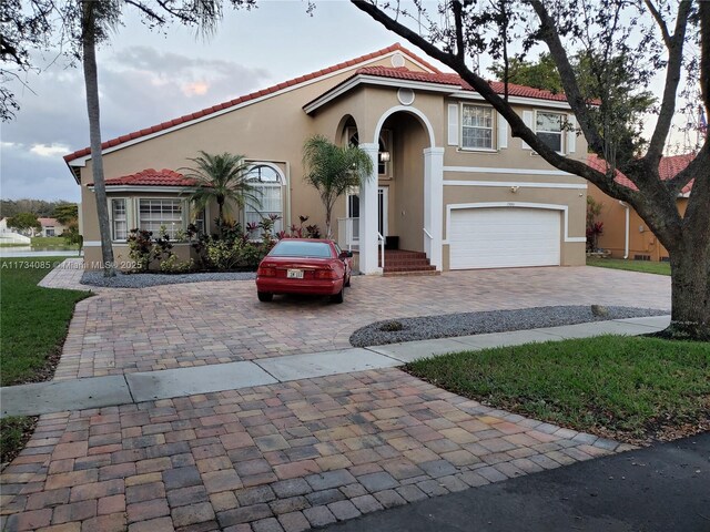 mediterranean / spanish home with a garage